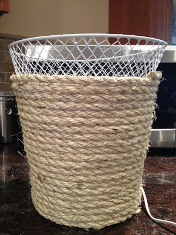 neat but very easy idea to makeover a plain trashcan with rope for extra decor points. Try it!
