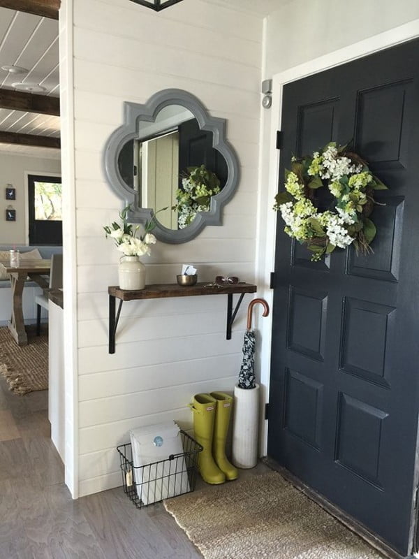 Check out this entryway decor idea with a storage shelf. Love it!
