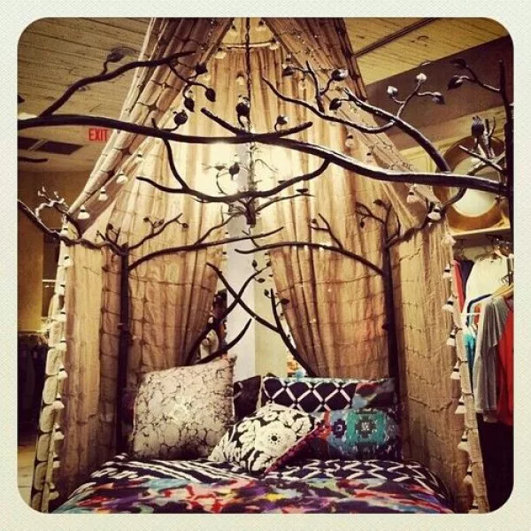 Love the boho decor of this decorative tree branch canopy 