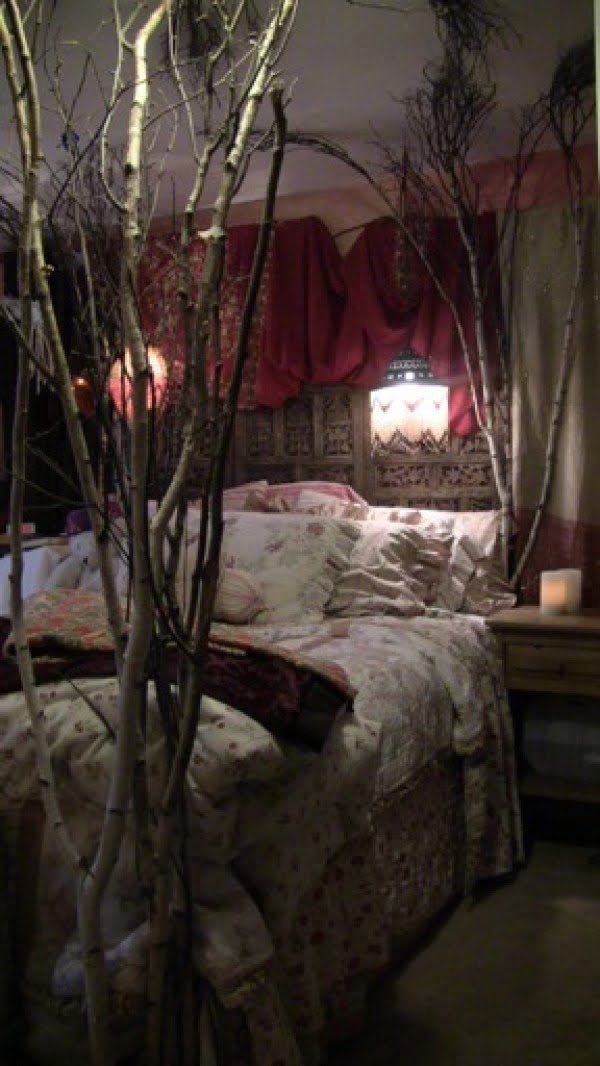 Love this eclectic bedroom design with bundles of tree branches for bed posts 