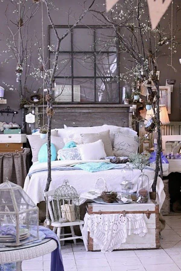 Love the rustic decor of this bedroom with dried tree branch bed posts 