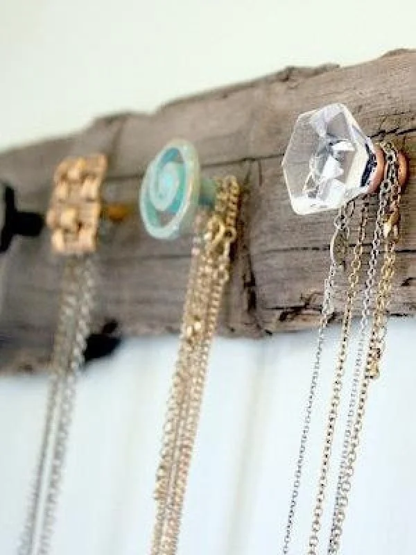 Love the shabby chic coat rack made of driftwood and crystal knobs 