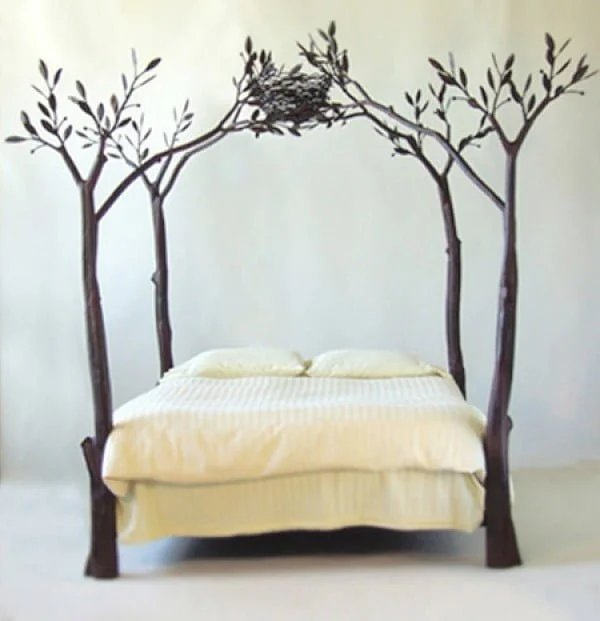 Adorable bed frame design with tree branches and a birds nest 