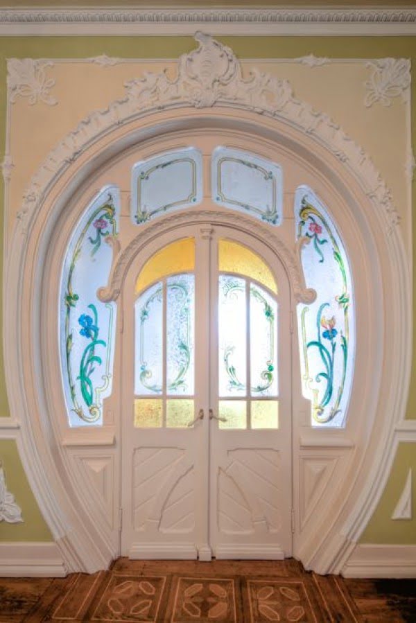 A unique shaped door with classic moldings and stained glass in a palace in Lisbon @Istandarddesign