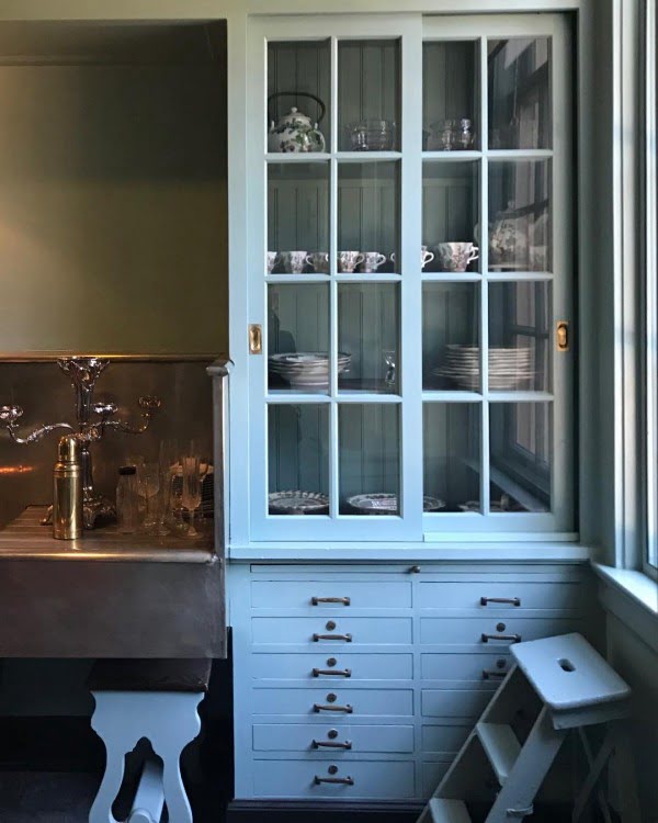 You have to see these soft blue kitchen cabinets with glass doors. Love it!