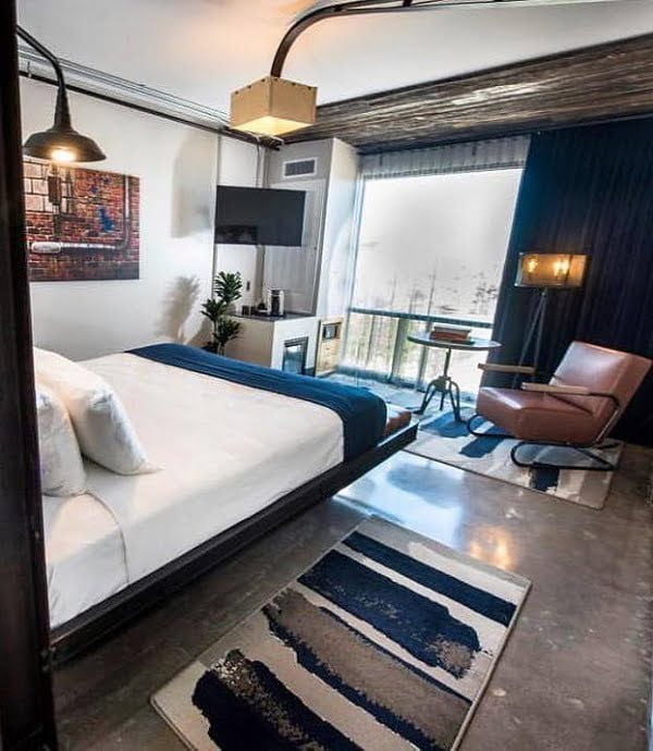 Great sleeping area in the industrial style. Love the floating bed design!    