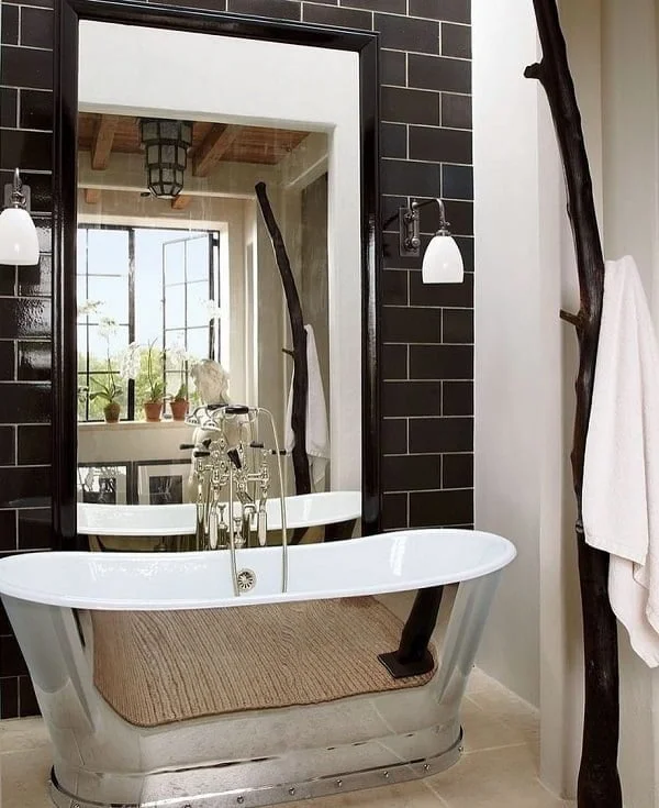 Modern and traditional at the same time! Love this winning combination of black tile and metallic  tub!   