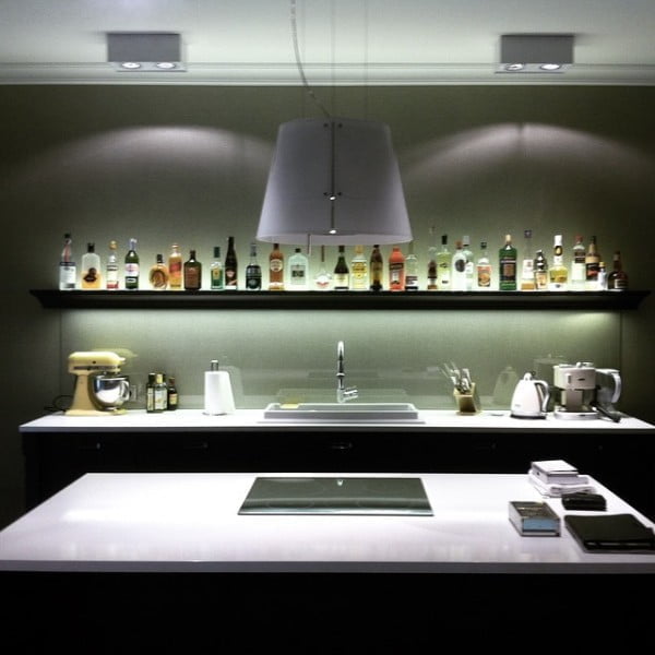 Check out this unusual kitchen design with a bar shelf backsplash. Love it!