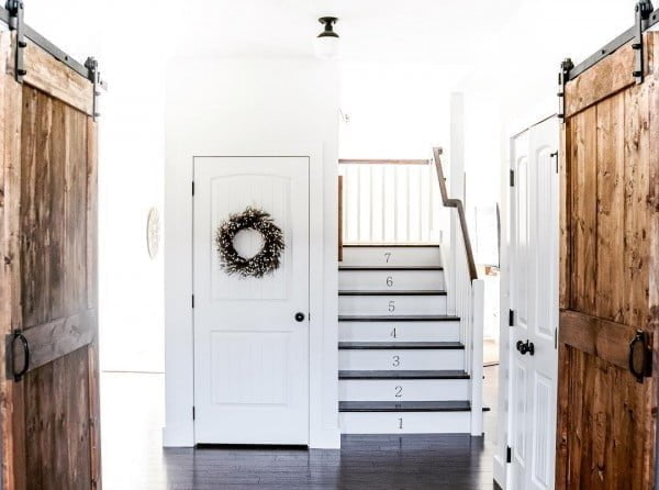Check out this entryway decor idea with barn doors. Love it!