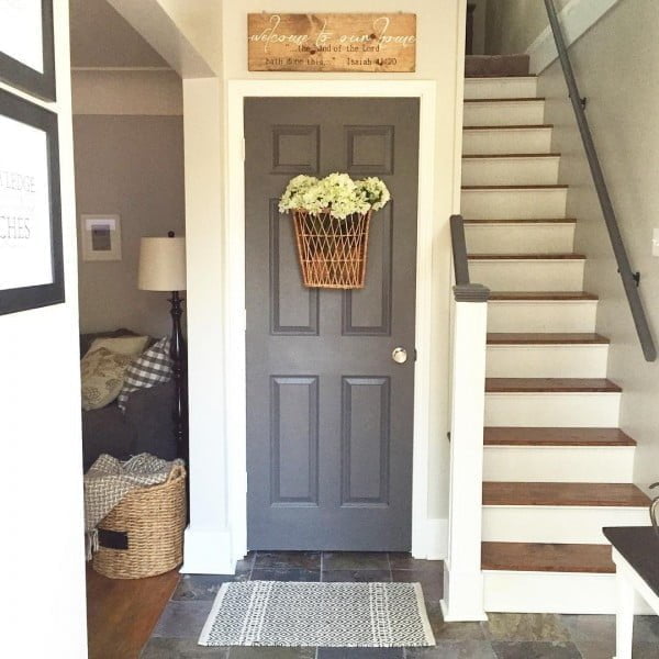 Check out this entryway decor idea with a basket door wreath. Love it!