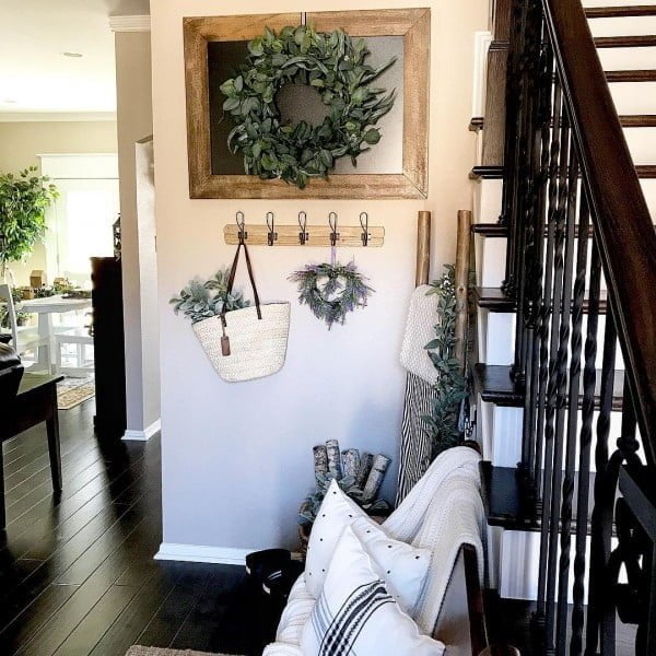 Check out this entryway decor idea with a framed wreath. Love it!