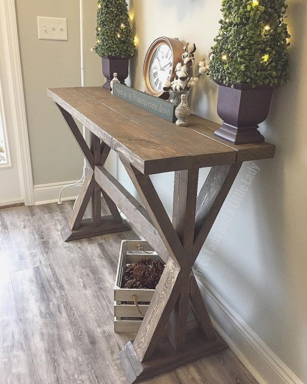 Check out this entryway decor idea with a x-base table. Love it!