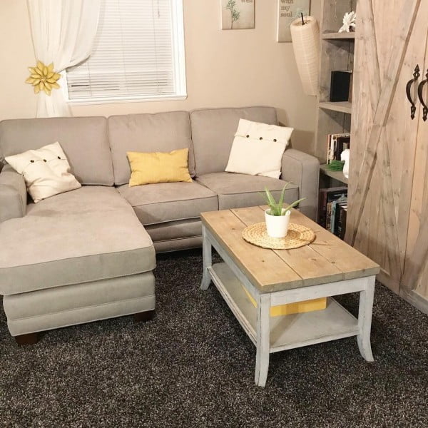 living room decor idea with a solid wood coffee table and a barn door bookshelf. Love it!