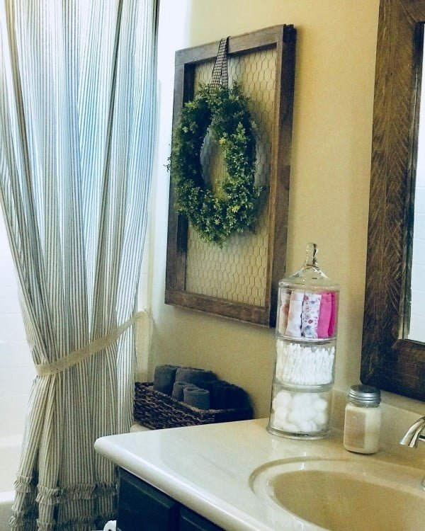 100 Cozy Rustic Farmhouse Bathroom Decor Ideas You Can Easily Copy - Check out this  bathroom decor idea with a  wreath. Love it!  