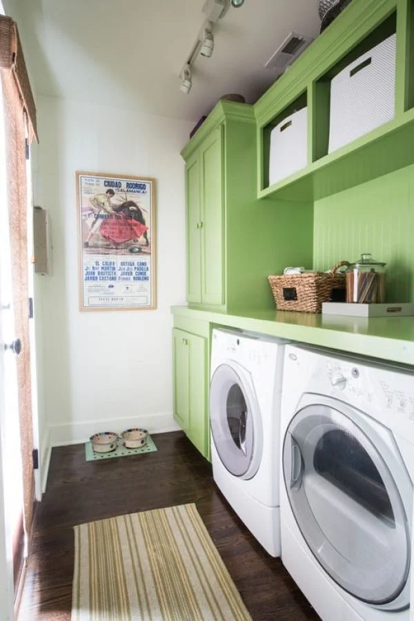 100 Fabulous Laundry Room Decor Ideas You Can Copy - You have to see this laundry room decor idea with green cabinets and wall art. Love it!