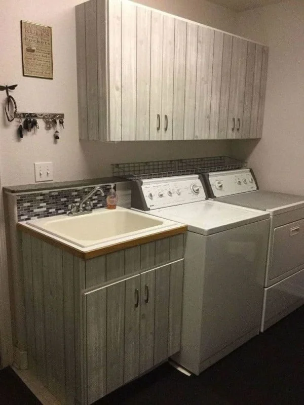 100 Fabulous Laundry Room Decor Ideas You Can Copy - You have to see this laundry room decor idea with cabinet wallpaper. Love it!