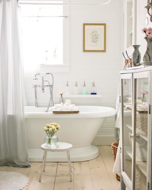 100 Cozy Rustic Farmhouse Bathroom Decor Ideas You Can Easily Copy - You have to see this bathroom decor idea with petite chair stand and hardwood flooring. Love it!  