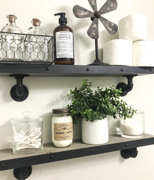 100 Cozy Rustic Farmhouse Bathroom Decor Ideas You Can Easily Copy - You have to see this bathroom decor idea with glass jars and pipe-like shelf holders. Love it!  