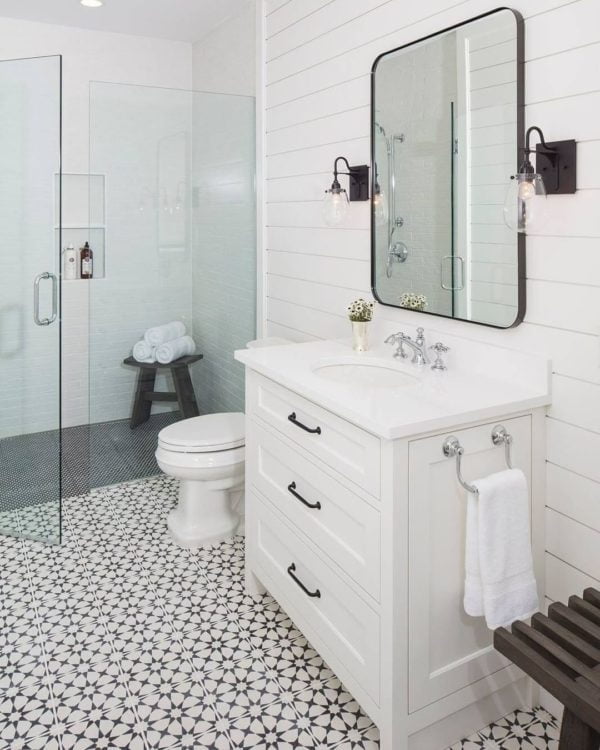 100 Cozy Rustic Farmhouse Bathroom Decor Ideas You Can Easily Copy - You have to see this bathroom decor idea with a wooden shower stool and multi-purpose white sink cabinet. Love it!  