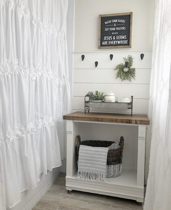 100 Cozy Rustic Farmhouse Bathroom Decor Ideas You Can Easily Copy - You have to see this bathroom decor idea with tin storage tray and hand-knitted storage basket. Love it!  