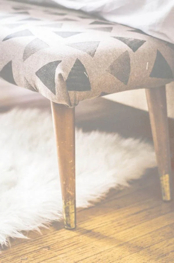 Check out the tutorial on how to make a DIY upholstered bedside bench. Looks easy enough!