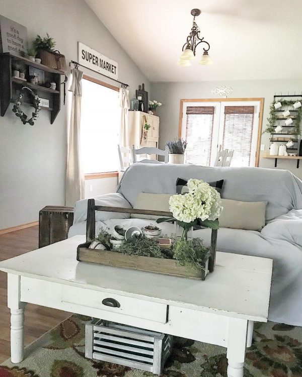 living room decor idea with a rustic nightstand and floral arrangements. Love it!