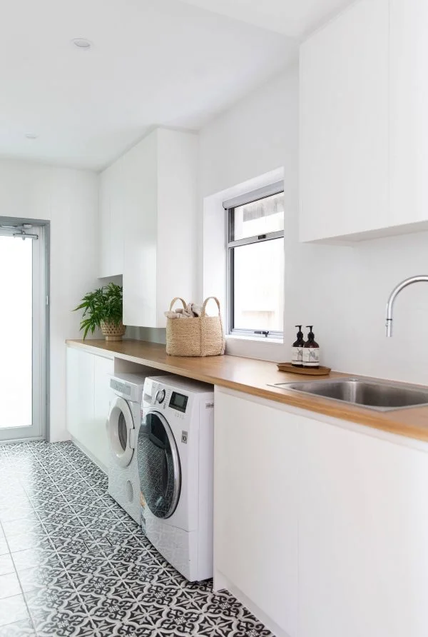 100 Fabulous Laundry Room Decor Ideas You Can Copy - You have to see this decor idea with relaxing white walls and soft wood countertops. Love it!