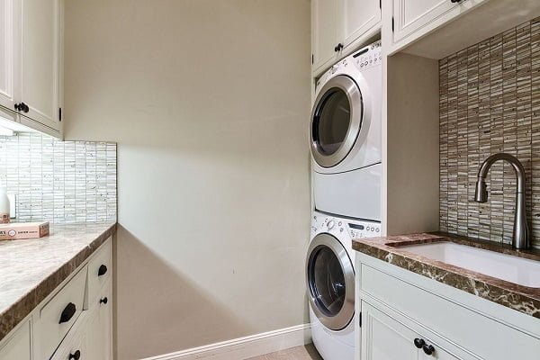100 Fabulous Laundry Room Decor Ideas You Can Copy - You have to see this decor idea with playful bamboo wall details and thoughtfully stacked washer/dryer. Love it!