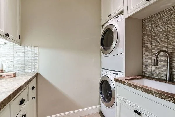 100 Fabulous Laundry Room Decor Ideas You Can Copy - You have to see this decor idea with playful bamboo wall details and thoughtfully stacked washer/dryer. Love it!