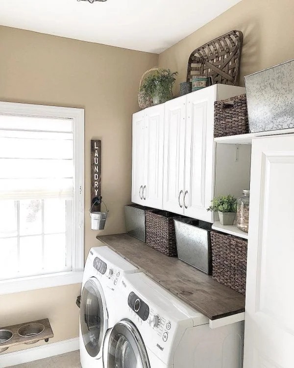 100 Fabulous Laundry Room Decor Ideas You Can Copy - You have to see this decor idea with metalic and wooden storag space and ornaments. Love it!
