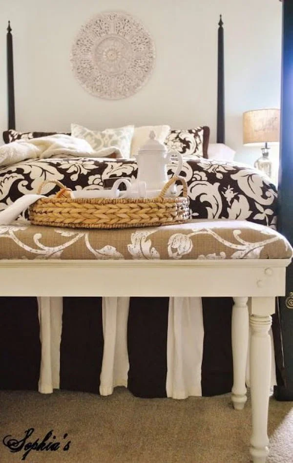 Check out the tutorial on how to make a DIY upholstered bench. Looks easy enough!