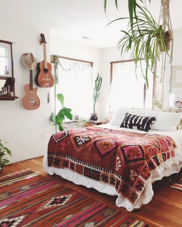 Hanging plants and musical instruments boho bedroom 