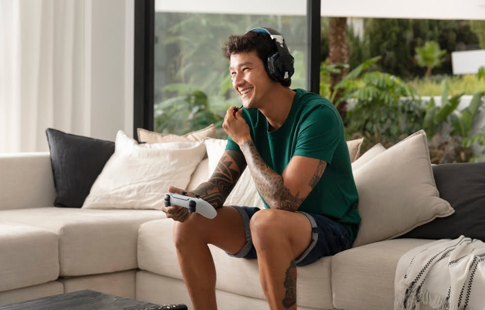 man using Bluetooth Headphones at home watching tv