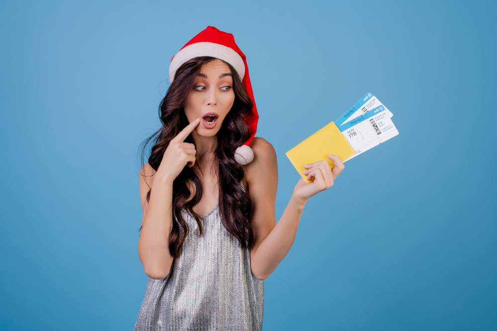 christmas girl holding tickets to a concert