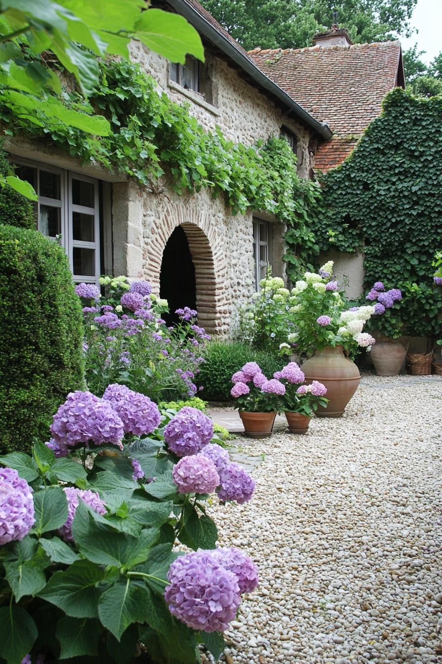 French cottage yard garden with arches geometric shrubs hydrangeas walls with vines 2