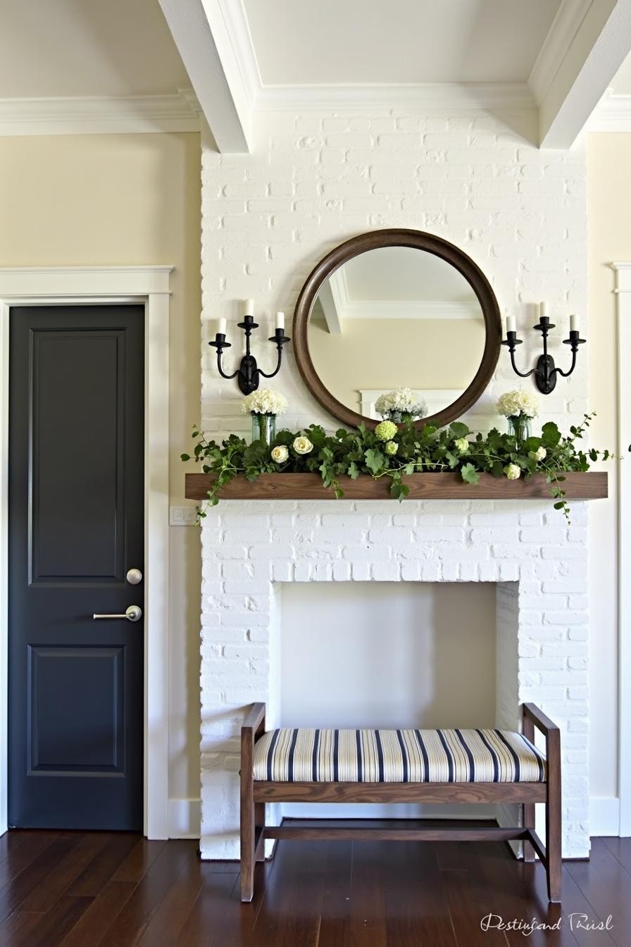 Mantel with mirror, lush greenery, and floral decor