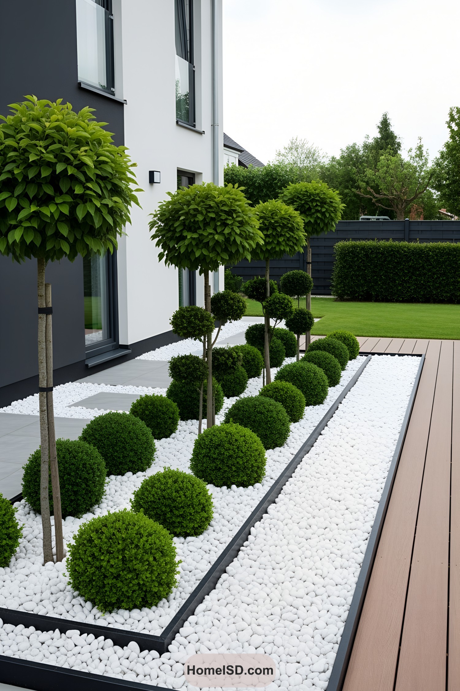 Neatly trimmed shrubs and small trees in a stone garden