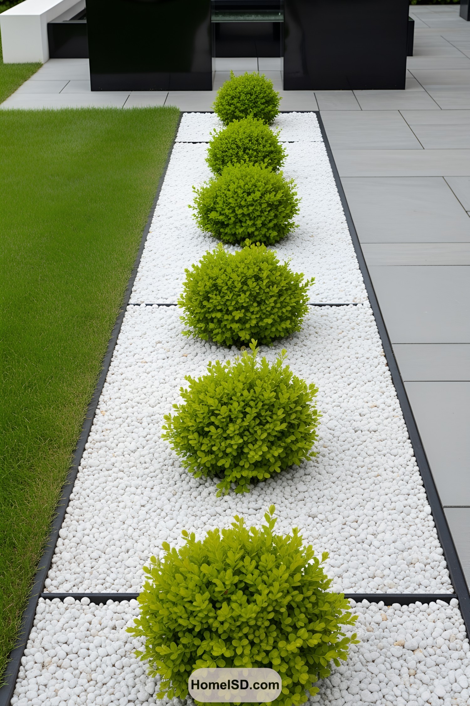 Pristine white pebbles with neatly aligned green shrubs