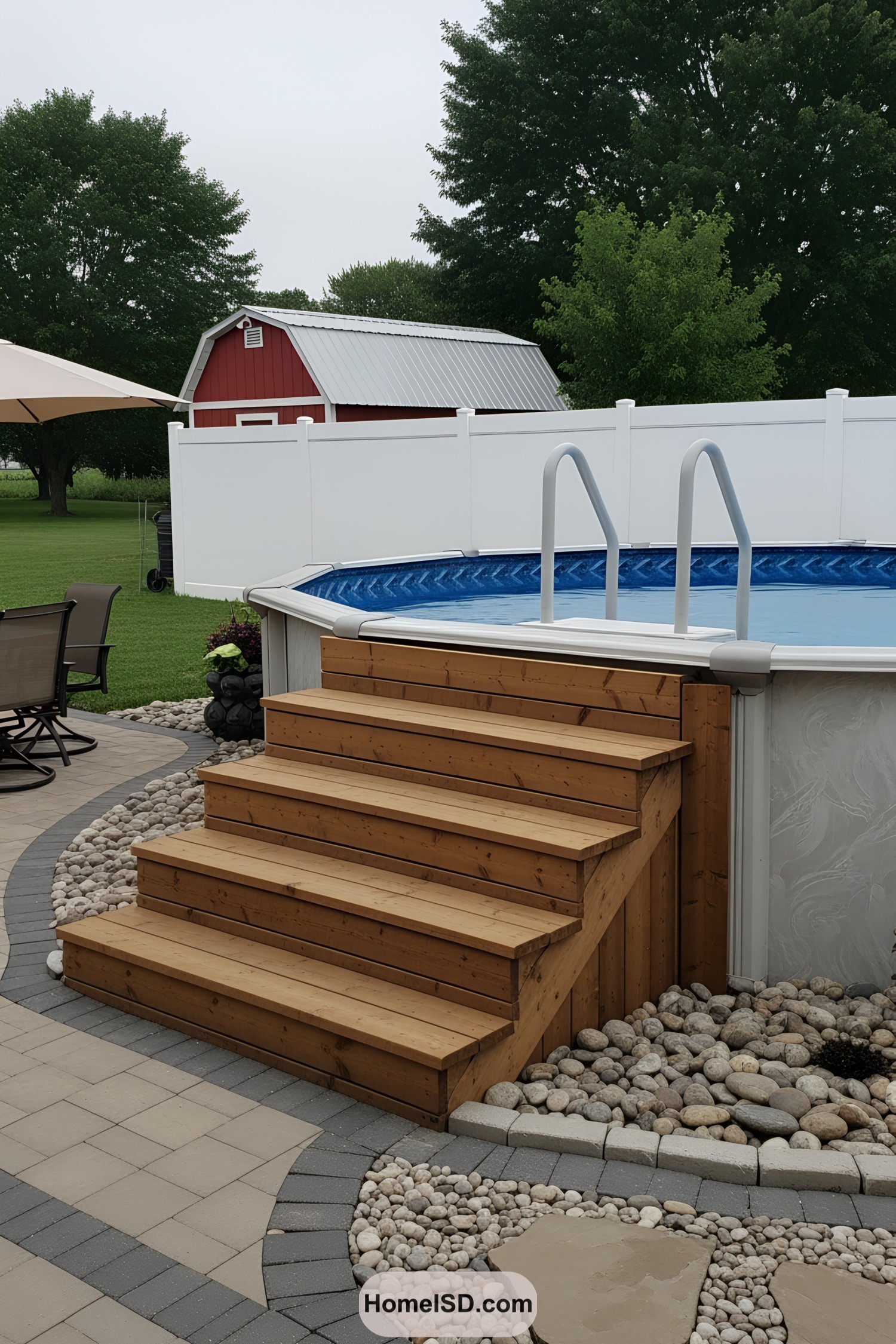 Above ground pool with wooden steps and a patio