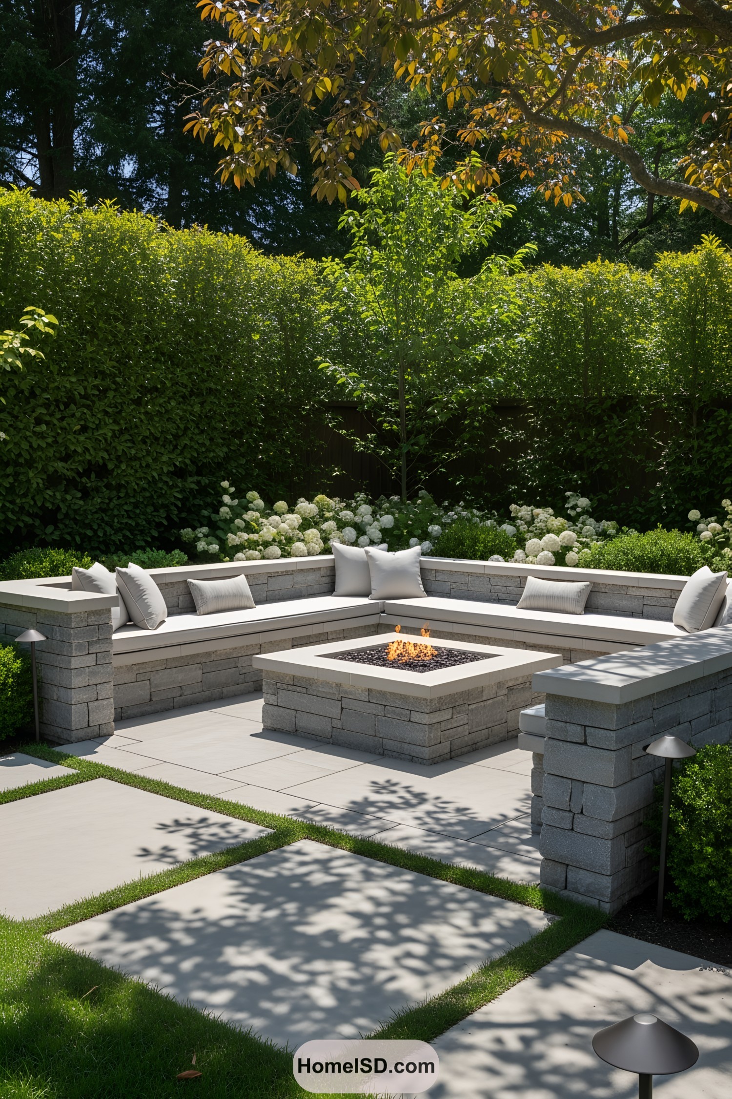 Brick fire pit with L-shaped seating and cushions