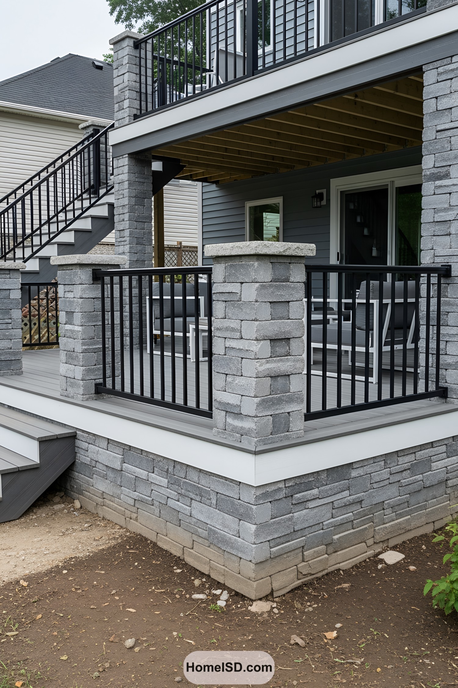 Deck with stone skirting and black railing