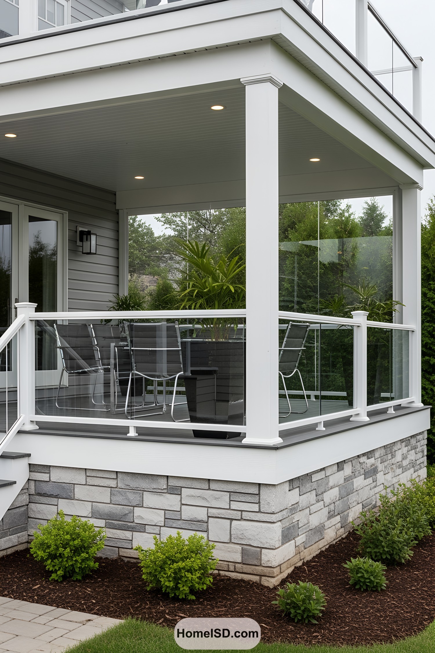 Contemporary deck with stone skirting and patio furniture