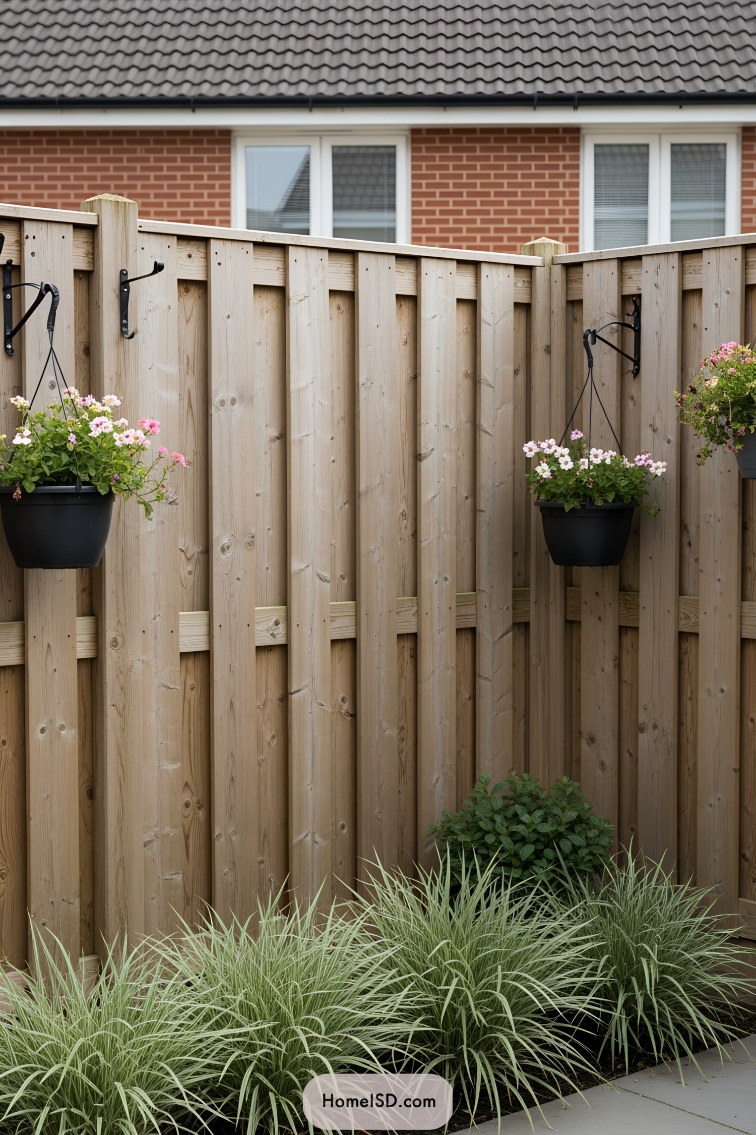 Wooden privacy fence with hanging planters