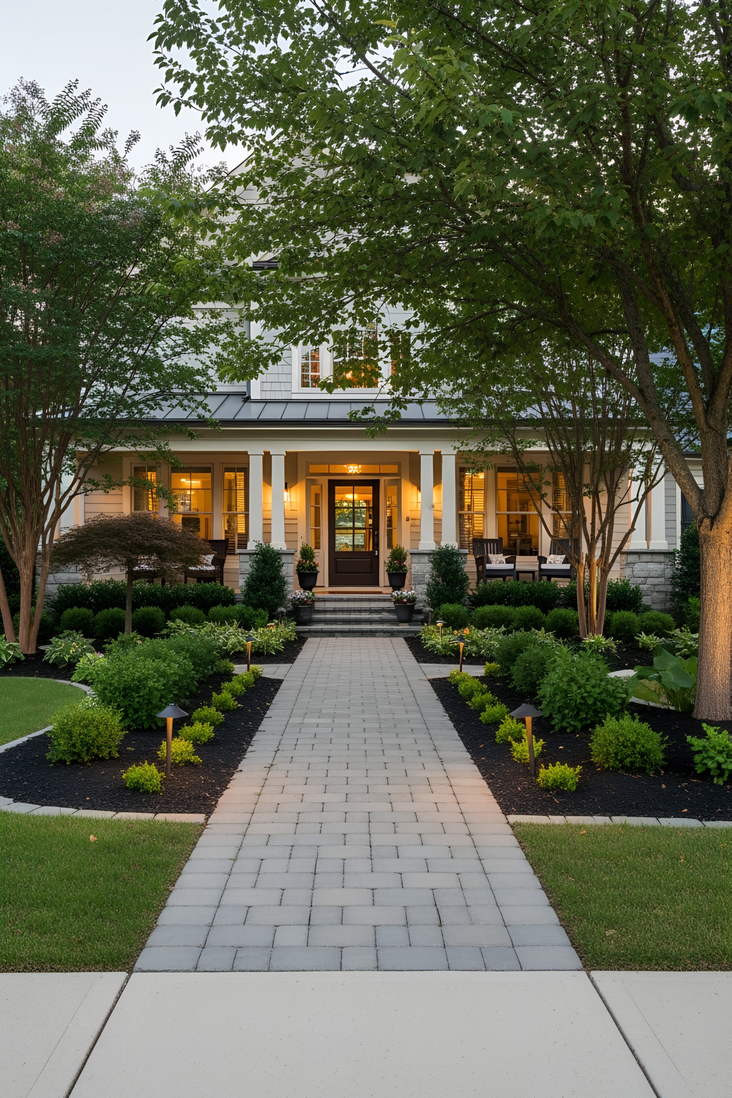 Charming house entrance with a paved walkway and lush greenery