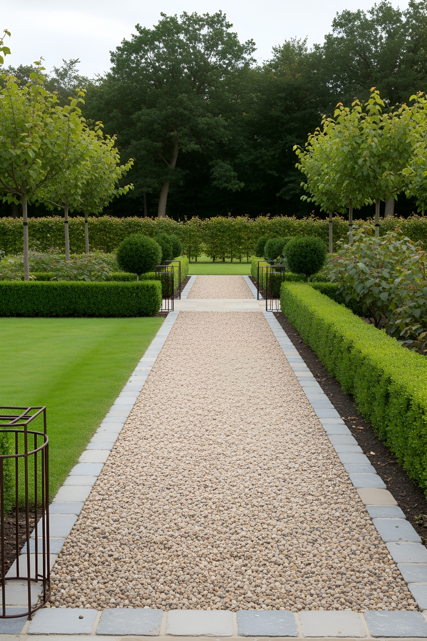 Straight gravel path lined by manicured greenery