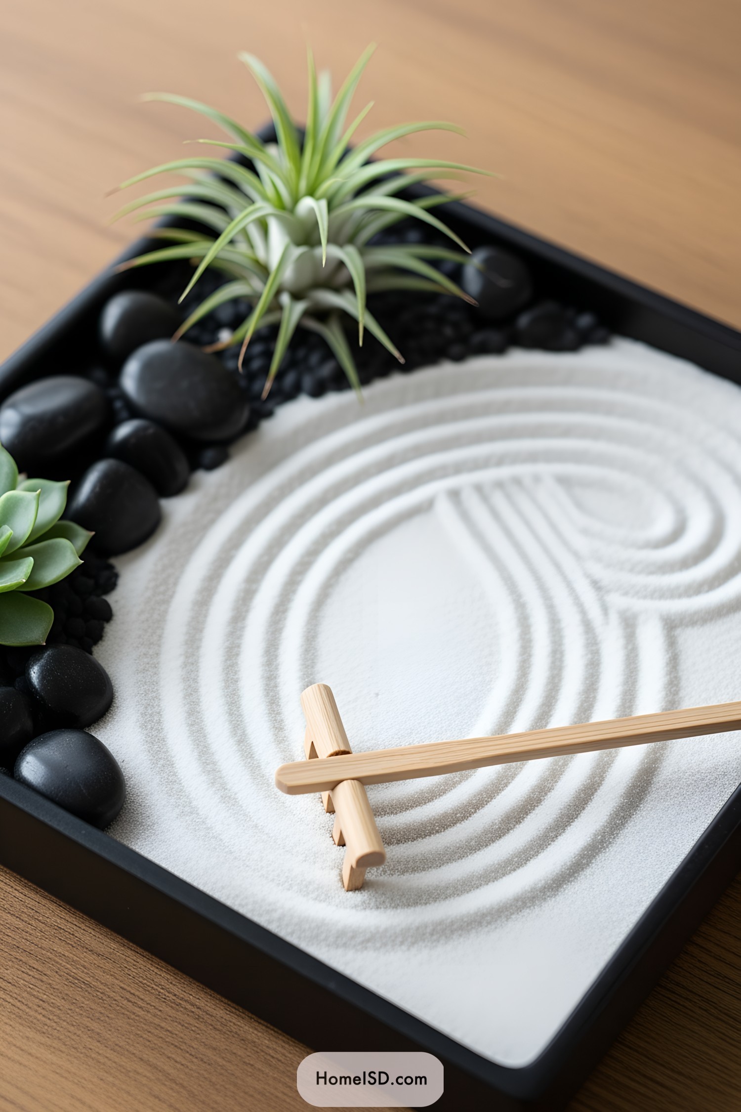 Miniature zen garden with sand, stones, and succulents