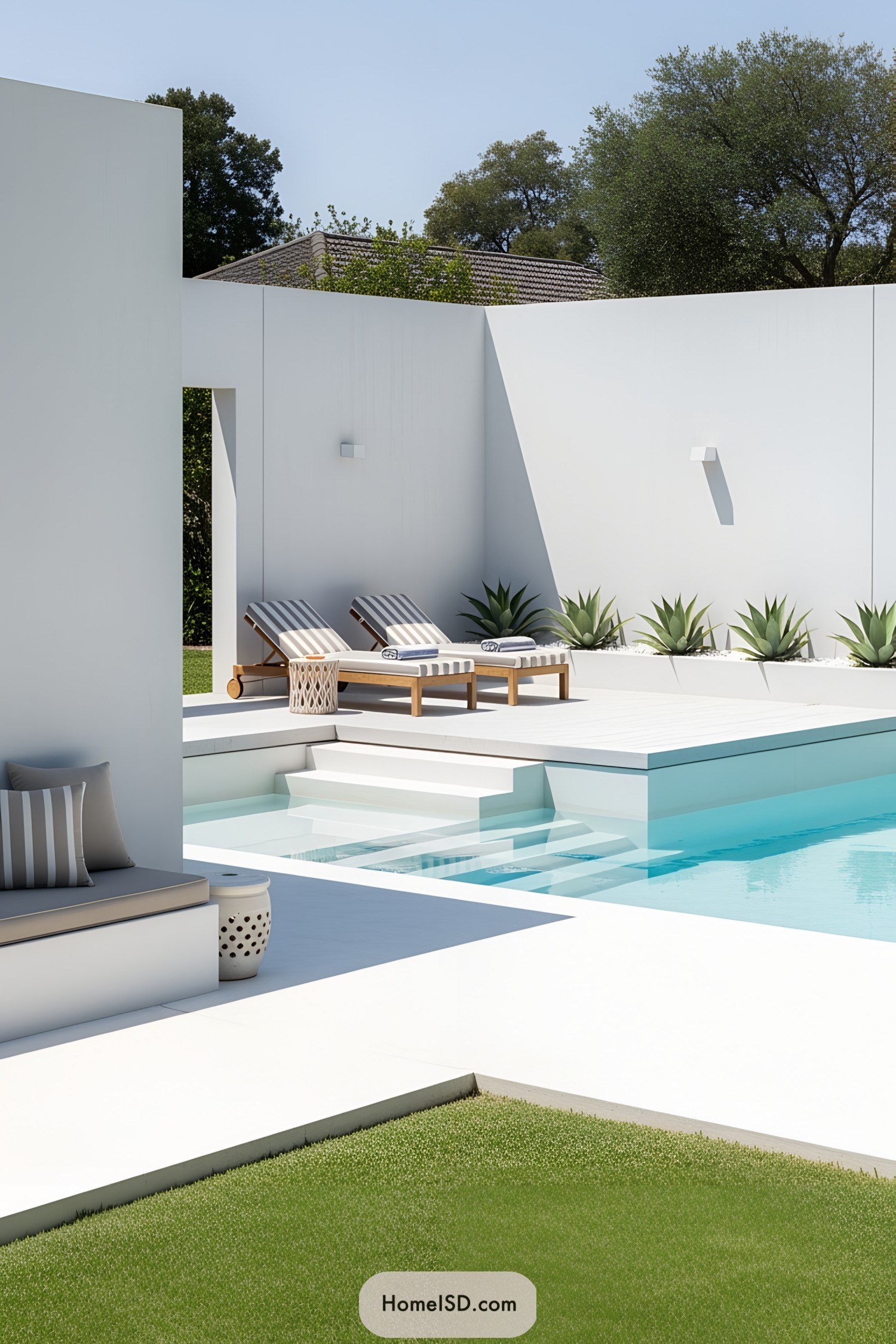 Compact modern poolside area with sun loungers