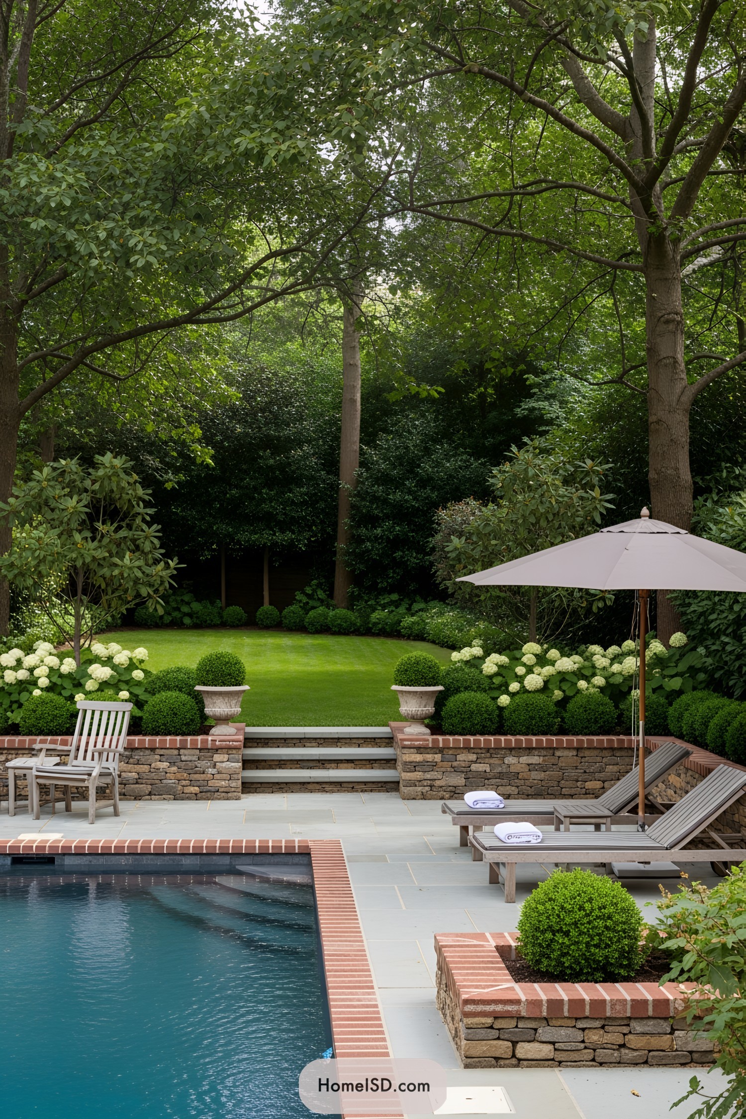 Elegant pool with lush garden backdrop and seating area