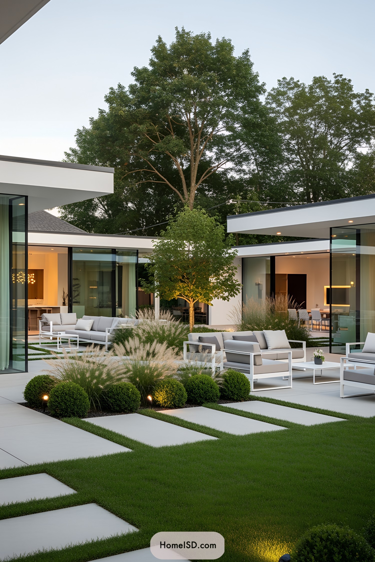 Modern patio with sleek furniture and lush greenery
