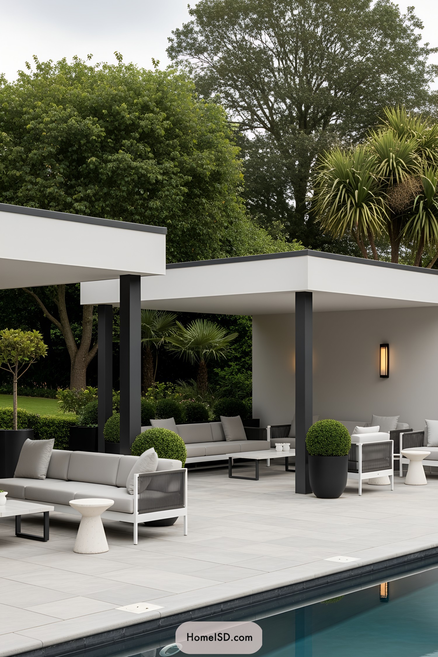 Modern poolside lounge with sleek furniture and lush greenery